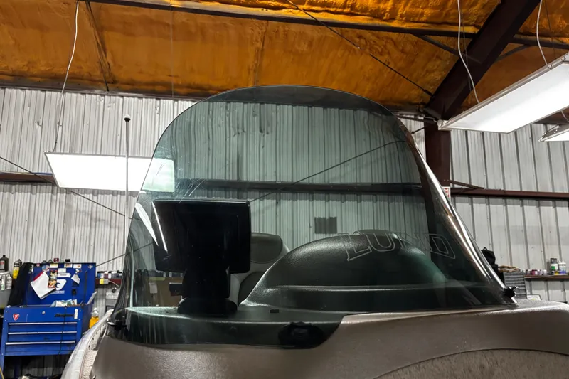 Slide: The Image of 2003 Lund 1650 Explorer SS boat windshield in a workshop setting. - 23