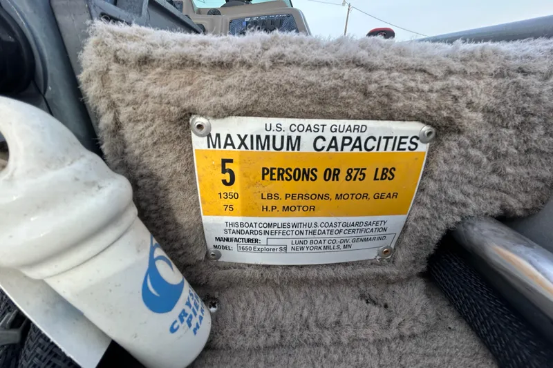 Slide: The Image of 2003 Lund 1650 Explorer SS capacity plate, 5 persons or 875 lbs, U.S. Coast Guard compliant. - 26