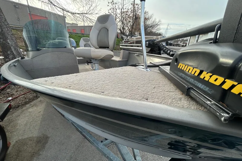 Slide: The Image of 2003 Lund 1650 Explorer SS boat with Minn Kota motor, parked outdoors. - 31