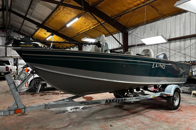 Slide: The Image of Interior of 2003 Lund 1650 Explorer SS boat with seating and storage compartments. - 5