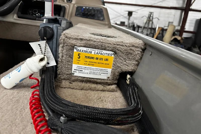 Slide: The Image of Minn Kota motor on 2003 Lund 1650 Explorer SS in a warehouse setting. - 9