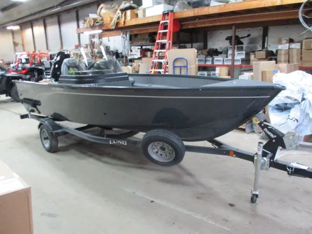 Slide: The Image of 2026 Lund 1650 Angler SS boat in warehouse on trailer. - 1