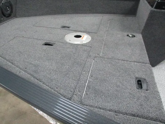 Slide: The Image of Interior of 2026 Lund 1650 Angler SS with gray carpet flooring. - 2