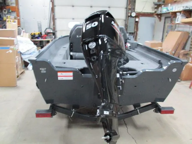 Slide: The Image of Rear view of a 2026 Lund 1650 Angler SS boat in a workshop. - 3