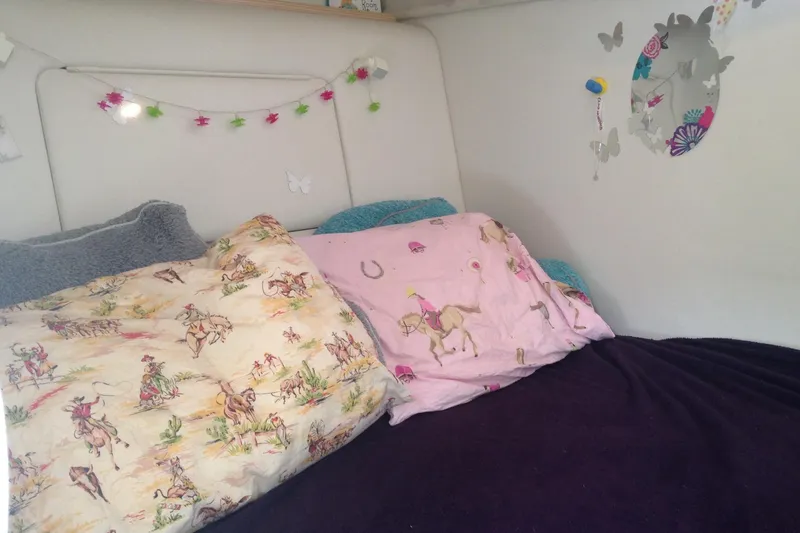 Slide: The Image of Cozy bed with colorful horse-themed pillows in a Maxum 3300 SCR, 2000 model. - 11