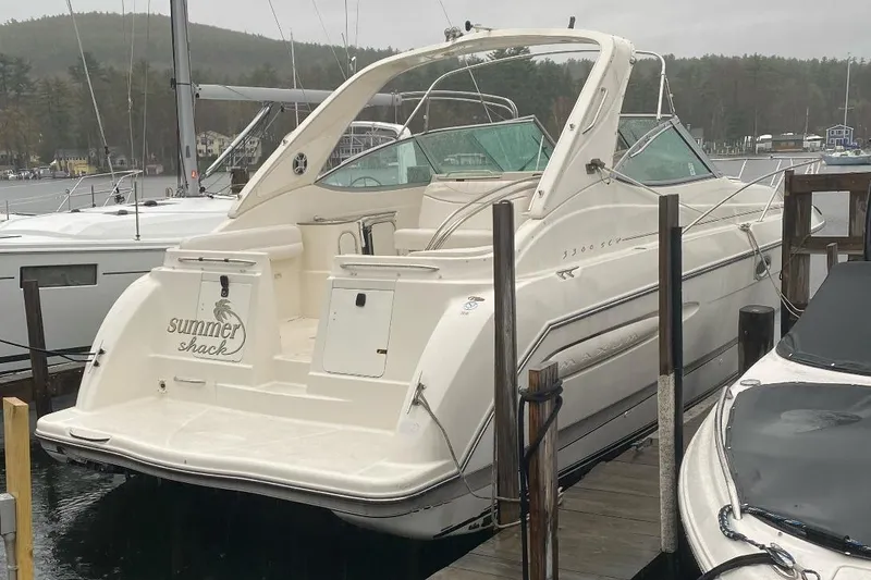 Slide: The Image of 2000 Maxum 3300 SCR boat docked, featuring "Summer Shack" text on the stern. - 3