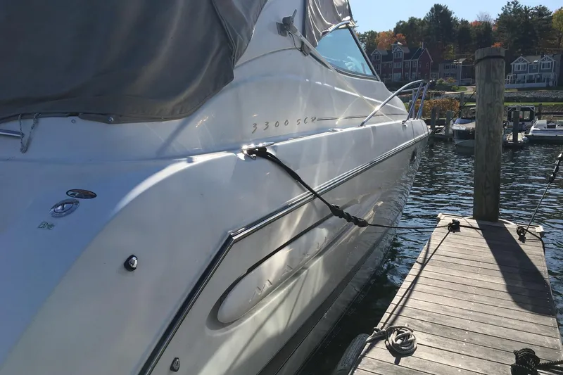 Slide: The Image of 2000 Maxum 3300 SCR boat docked at a marina, side view with cover. - 6