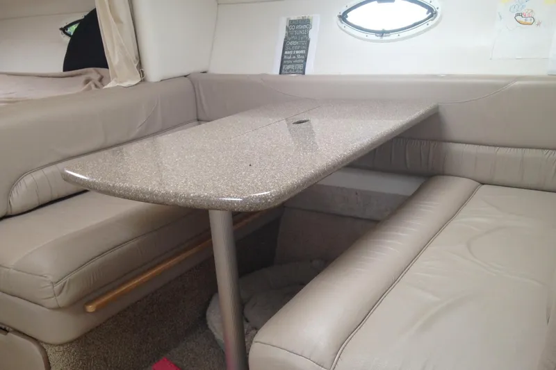 Slide: The Image of Interior of 2000 Maxum 3300 SCR boat with beige seating and table. - 8