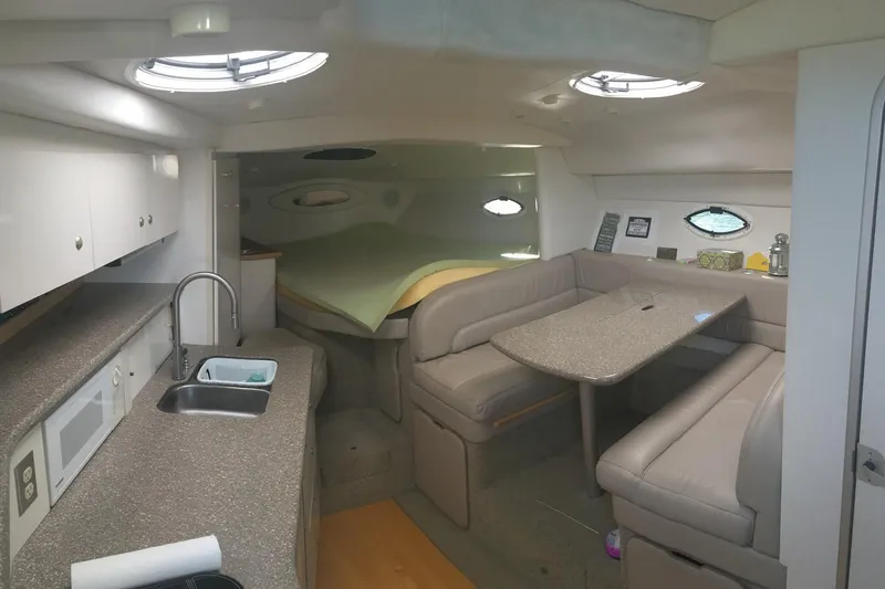 Slide: The Image of Interior of 2000 Maxum 3300 SCR yacht with kitchenette and seating area. - 9