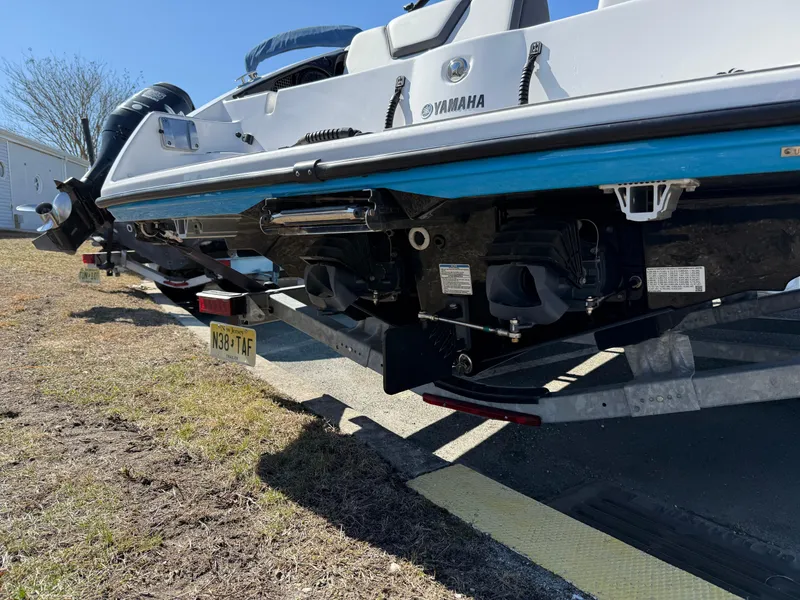 Slide: The Image of 2023 Yamaha Boats AR250 on trailer, showcasing dual engines and sleek design. - 10