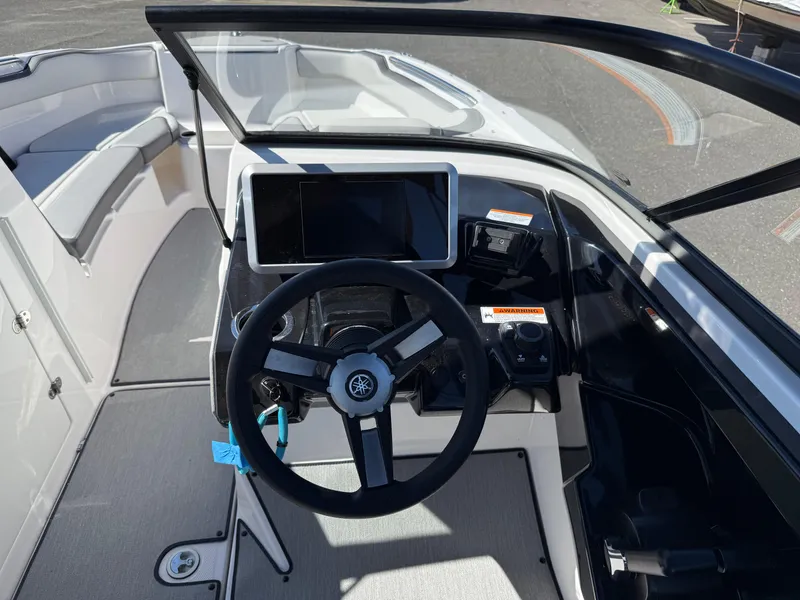 Slide: The Image of 2023 Yamaha Boats AR250 cockpit with steering wheel and digital display. - 12