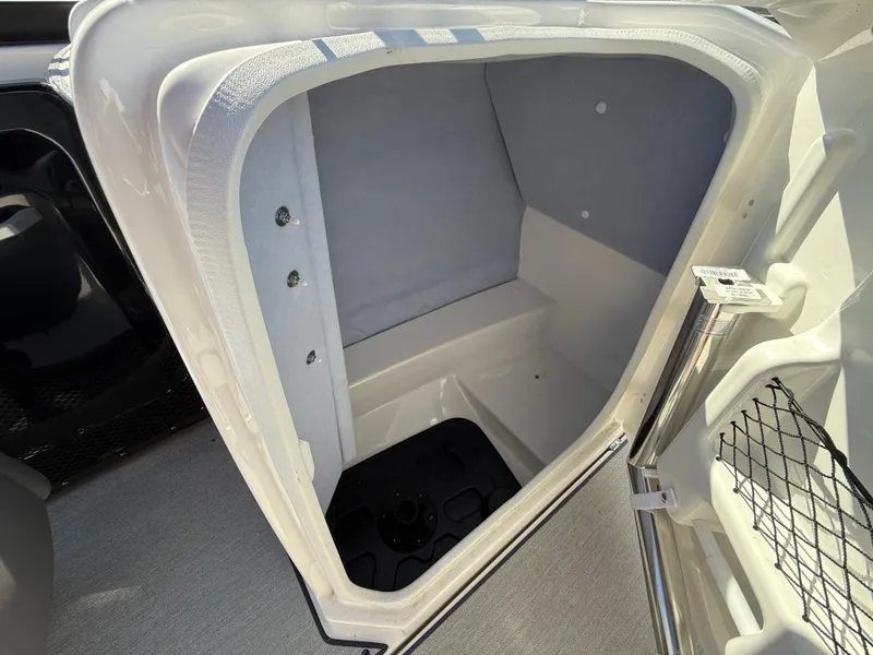 Slide: The Image of 2023 Yamaha Boats AR250 interior storage compartment, open and empty. - 18