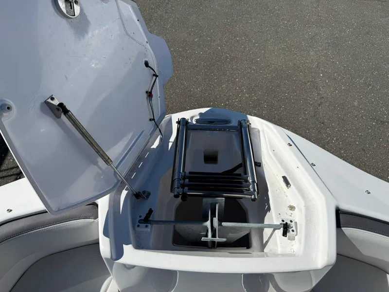 Slide: The Image of 2023 Yamaha AR250 boat anchor compartment with open hatch and ladder. - 19