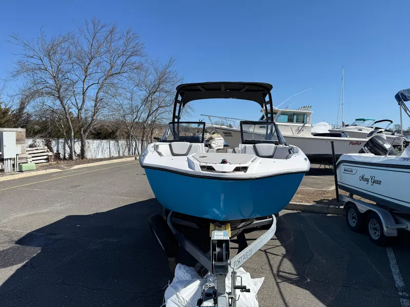 Slide: The Image of 2023 Yamaha Boats AR250 on trailer, parked outdoors under clear blue sky. - 3