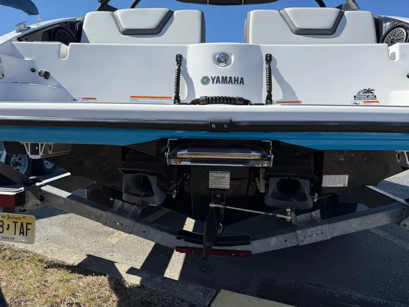 Slide: The Image of 2023 Yamaha Boats AR250 rear view on trailer, showcasing dual engines and seating. - 9