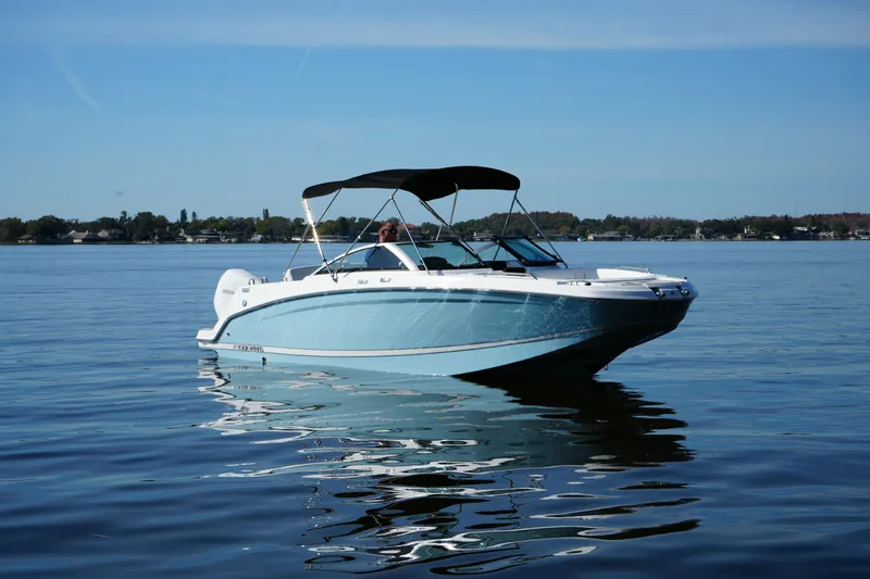 Slide: The Image of 2026 Four Winns HD3 OB boat on calm lake waters under clear sky. - 22