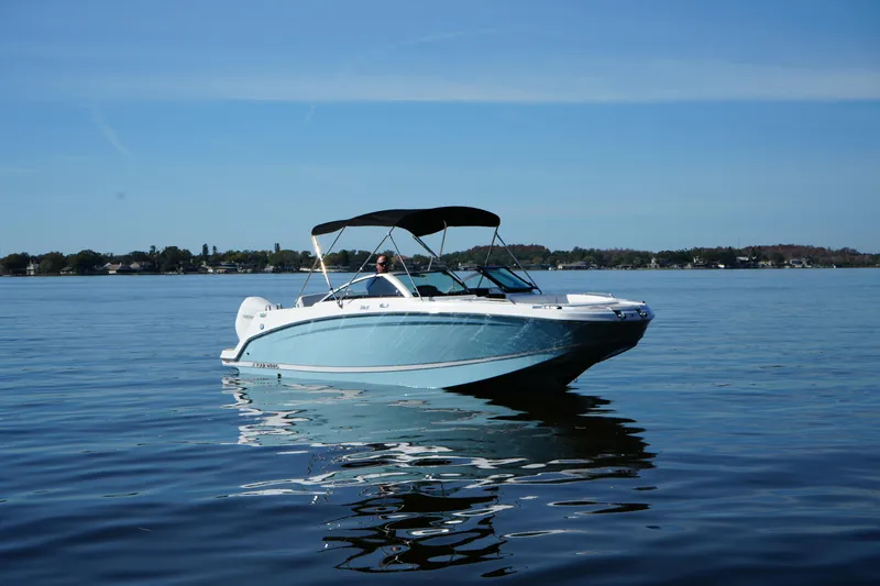 Slide: The Image of 2026 Four Winns HD3 OB boat on calm lake under clear blue sky. - 23