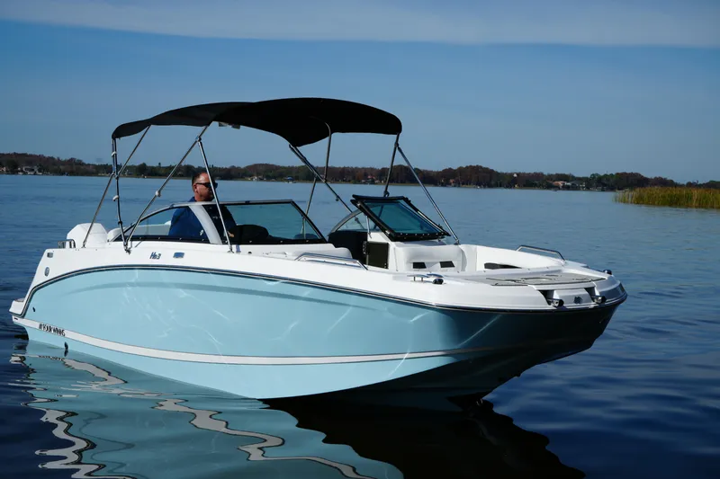 Slide: The Image of 2026 Four Winns HD3 OB boat on calm lake with canopy and driver. - 29