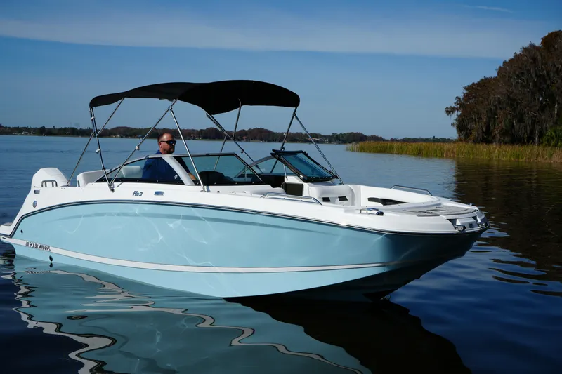 Slide: The Image of 2026 Four Winns HD3 OB boat on calm lake with canopy and driver. - 30