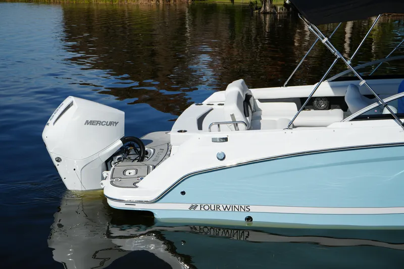 Slide: The Image of 2026 Four Winns HD3 OB boat with Mercury outboard engine on calm water. - 35