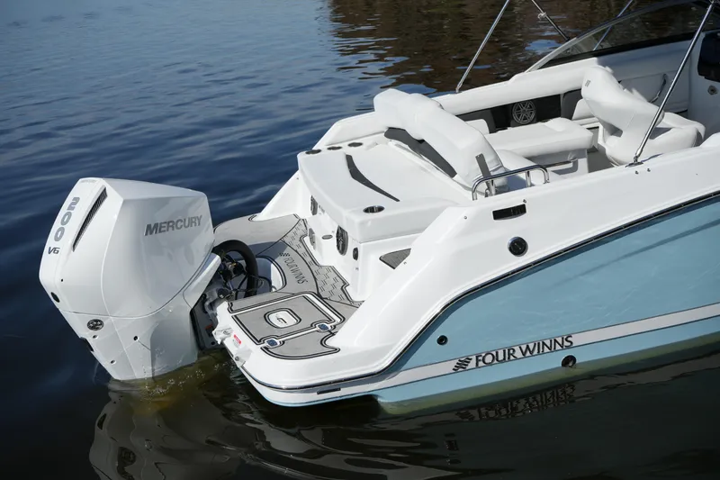 Slide: The Image of 2026 Four Winns HD3 OB boat with Mercury 200 V6 engine on calm water. - 38