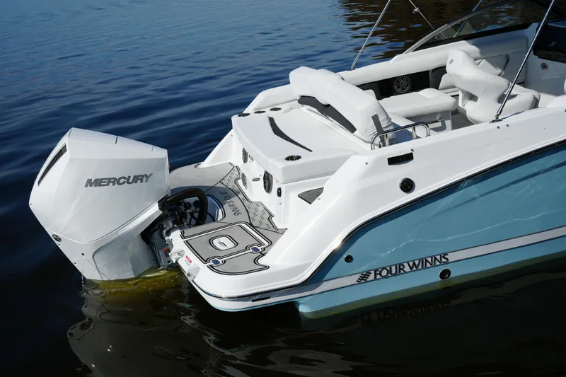 Slide: The Image of 2026 Four Winns HD3 OB boat with Mercury outboard engine on calm water. - 39