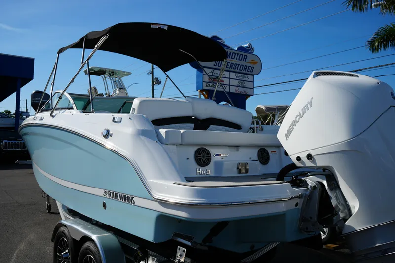 Slide: The Image of 2026 Four Winns HD3 OB boat with Mercury outboard motor, parked on a trailer. - 5