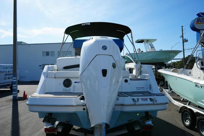 Slide: The Image of 2026 Four Winns HD3 OB boat with outboard motor, parked outdoors. - 7