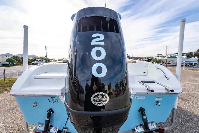 Slide: The Image of 2021 Sea Pro 219 Center Console boat with powerful 200 HP engine, docked outdoors. - 10