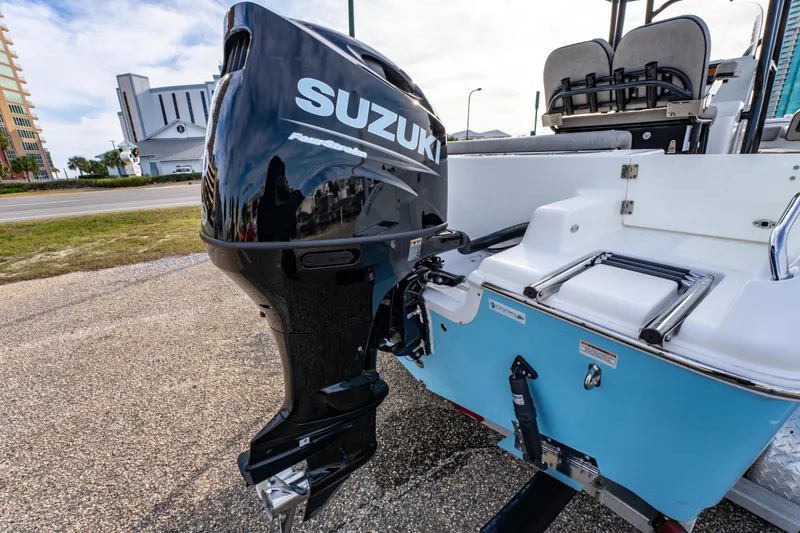 Slide: The Image of 2021 Sea Pro 219 Center Console with Suzuki outboard motor, parked on a trailer. - 11