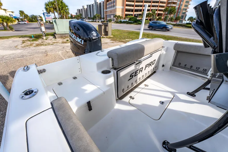 Slide: The Image of 2021 Sea Pro 219 Center Console boat with Suzuki engine, parked near a coastal road. - 13
