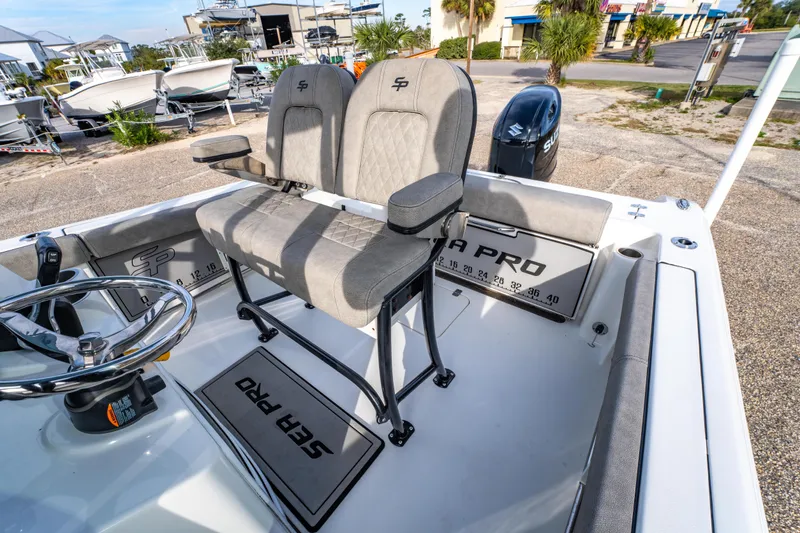 Slide: The Image of 2021 Sea Pro 219 Center Console boat interior with dual seats and steering wheel. - 15