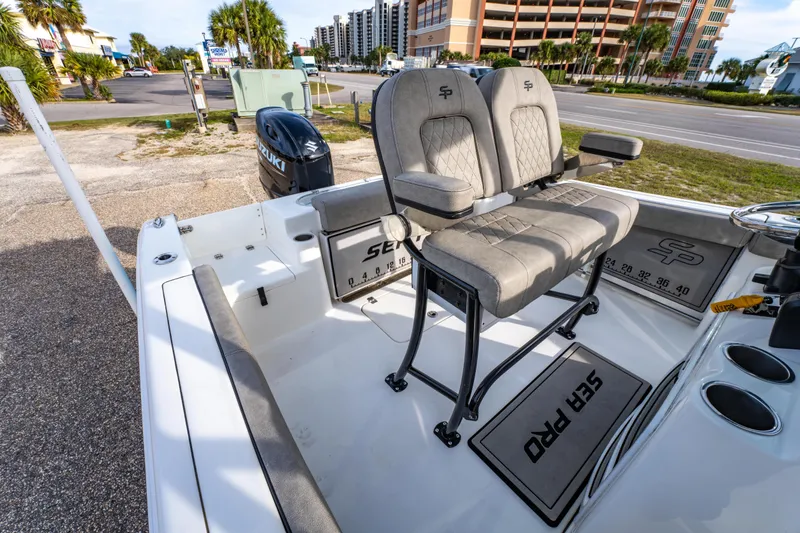 Slide: The Image of 2021 Sea Pro 219 Center Console boat interior with dual seats and Suzuki engine. - 16