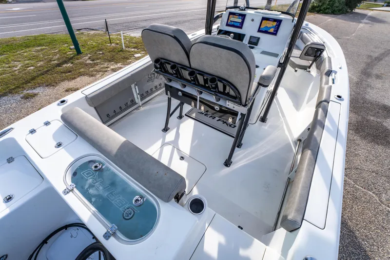 Slide: The Image of 2021 Sea Pro 219 Center Console boat interior with seating and navigation displays. - 17