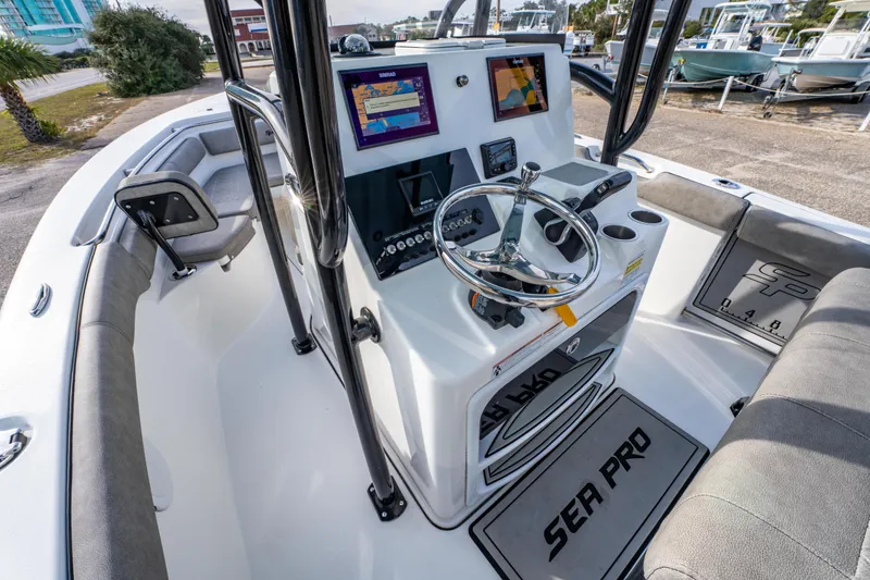 Slide: The Image of 2021 Sea Pro 219 Center Console boat interior with steering wheel and navigation display. - 19