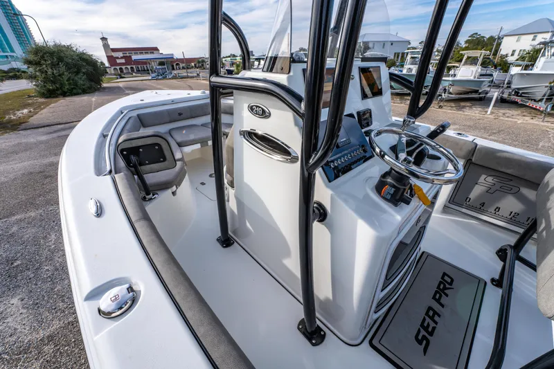 Slide: The Image of 2021 Sea Pro 219 Center Console boat interior with steering wheel and seating. - 23