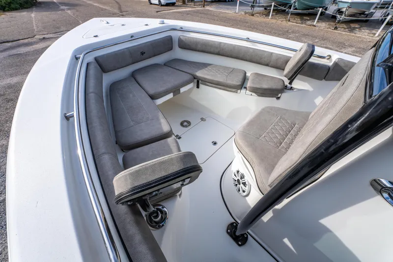 Slide: The Image of 2021 Sea Pro 219 Center Console boat interior with cushioned seating and modern design. - 24