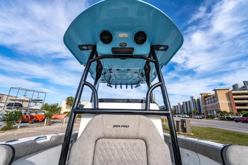 Slide: The Image of 2021 Sea Pro 219 Center Console boat with blue T-top and urban background. - 29