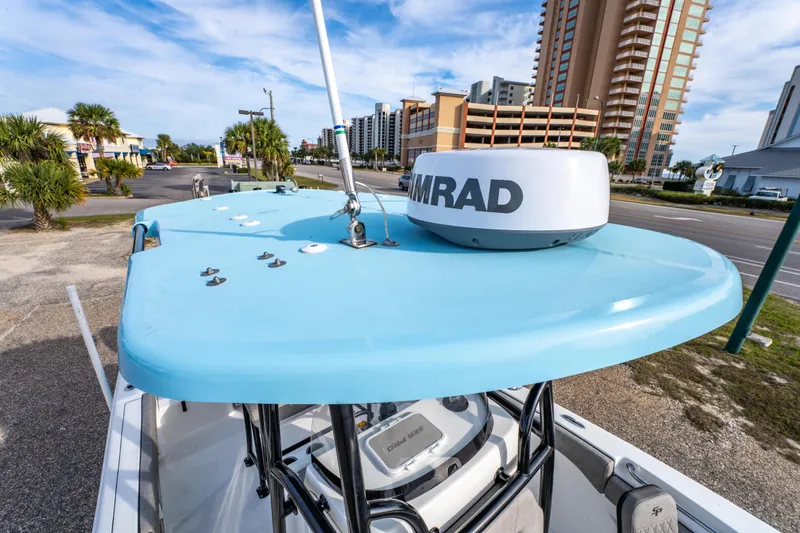 Slide: The Image of 2021 Sea Pro 219 Center Console boat with radar, parked near buildings and palm trees. - 31