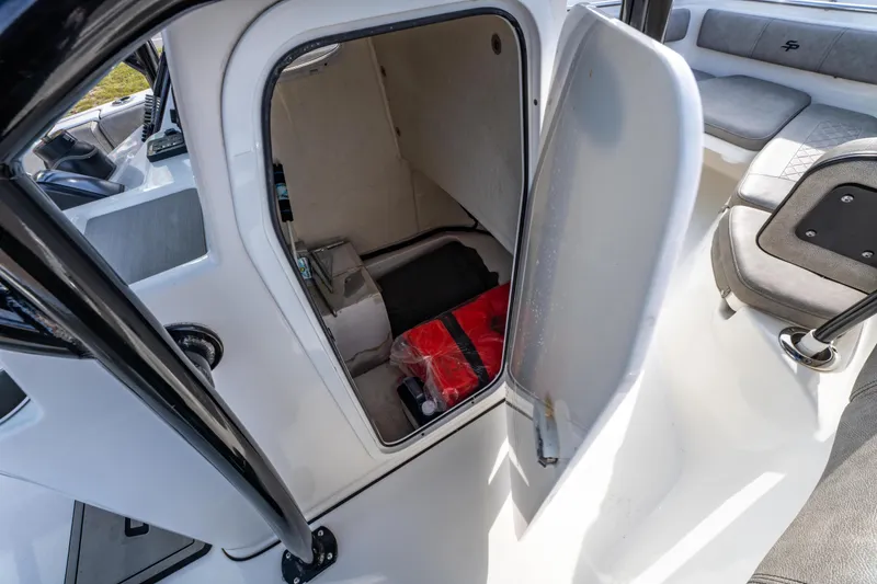 Slide: The Image of 2021 Sea Pro 219 Center Console boat interior storage compartment with open door. - 32