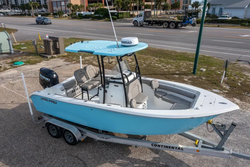 Slide: The Image of 2021 Sea Pro 219 Center Console boat on trailer, parked near a road. - 34