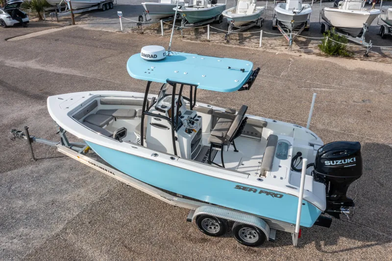 Slide: The Image of 2021 Sea Pro 219 Center Console boat on trailer, featuring Suzuki outboard motor. - 35