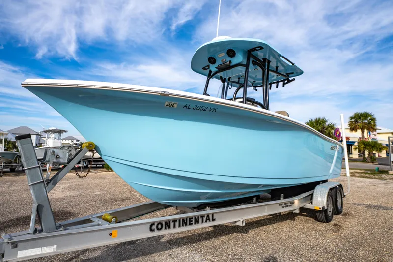 Slide: The Image of 2021 Sea Pro 219 Center Console boat on trailer, under a clear blue sky. - 7