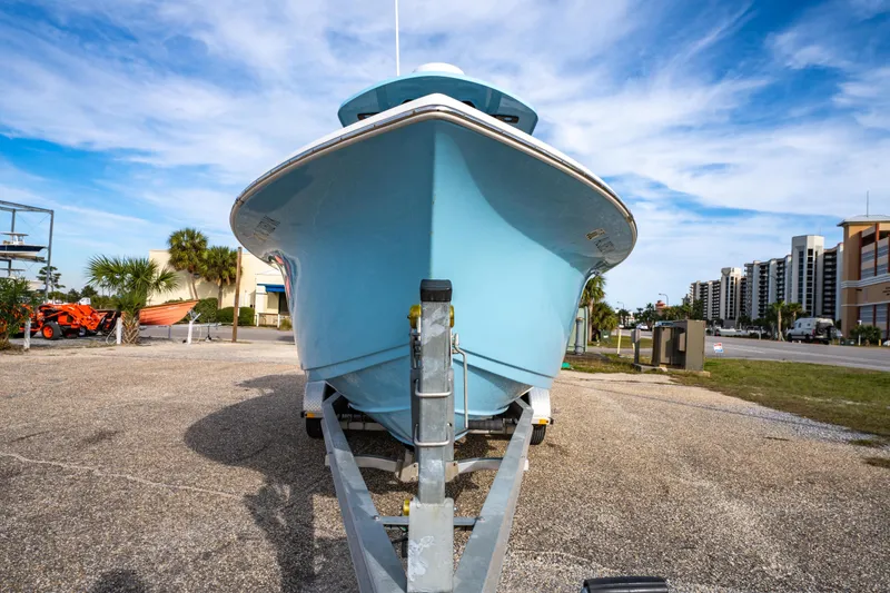 Slide: The Image of 2021 Sea Pro 219 Center Console boat on trailer, parked outdoors under blue sky. - 8