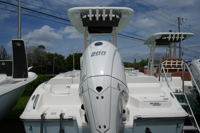 Slide: The Image of 2026 Key West 219 FS boat with powerful 200 HP engine, docked outdoors. - 10