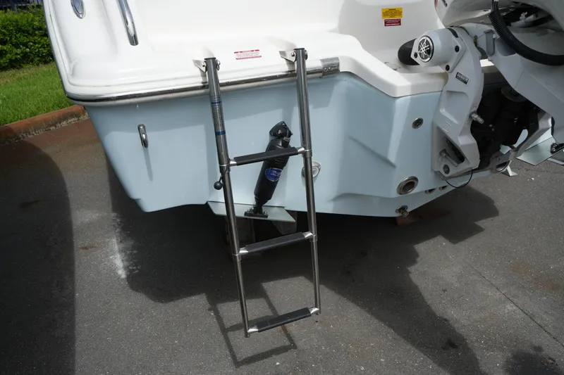 Slide: The Image of Rear view of 2026 Key West 219 FS boat with ladder and motor. - 12