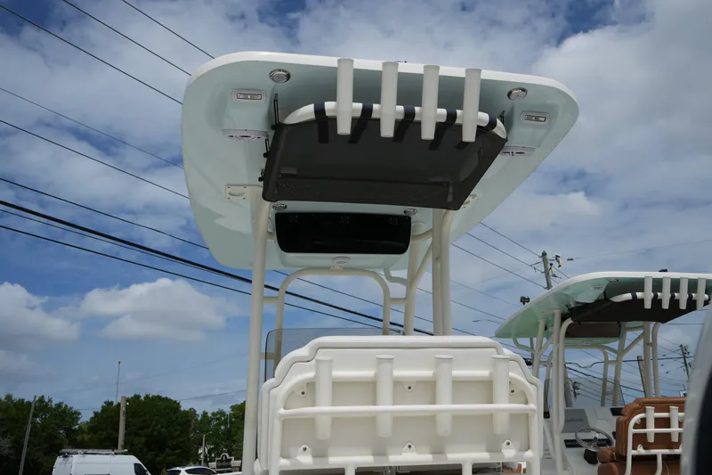 Slide: The Image of 2026 Key West 219 FS boat with T-top and rod holders under a cloudy sky. - 13