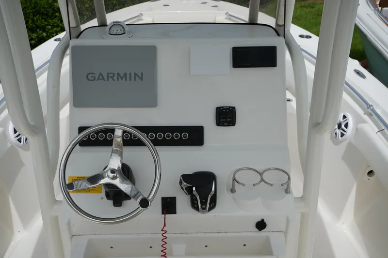 Slide: The Image of 2026 Key West 219 FS boat console with Garmin navigation system and steering wheel. - 18