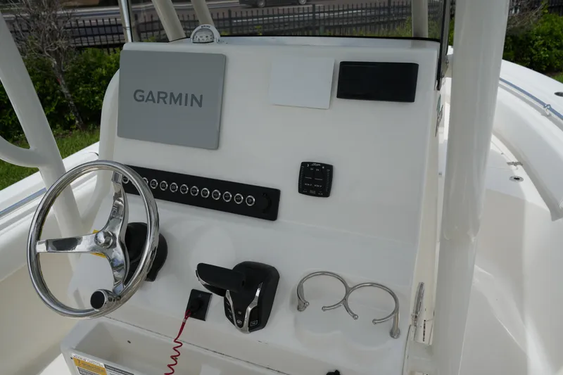 Slide: The Image of 2026 Key West 219 FS boat dashboard with Garmin navigation system and steering wheel. - 19