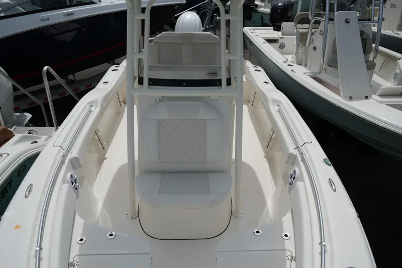 Slide: The Image of 2026 Key West 219 FS boat interior with seating and console, docked among other boats. - 24